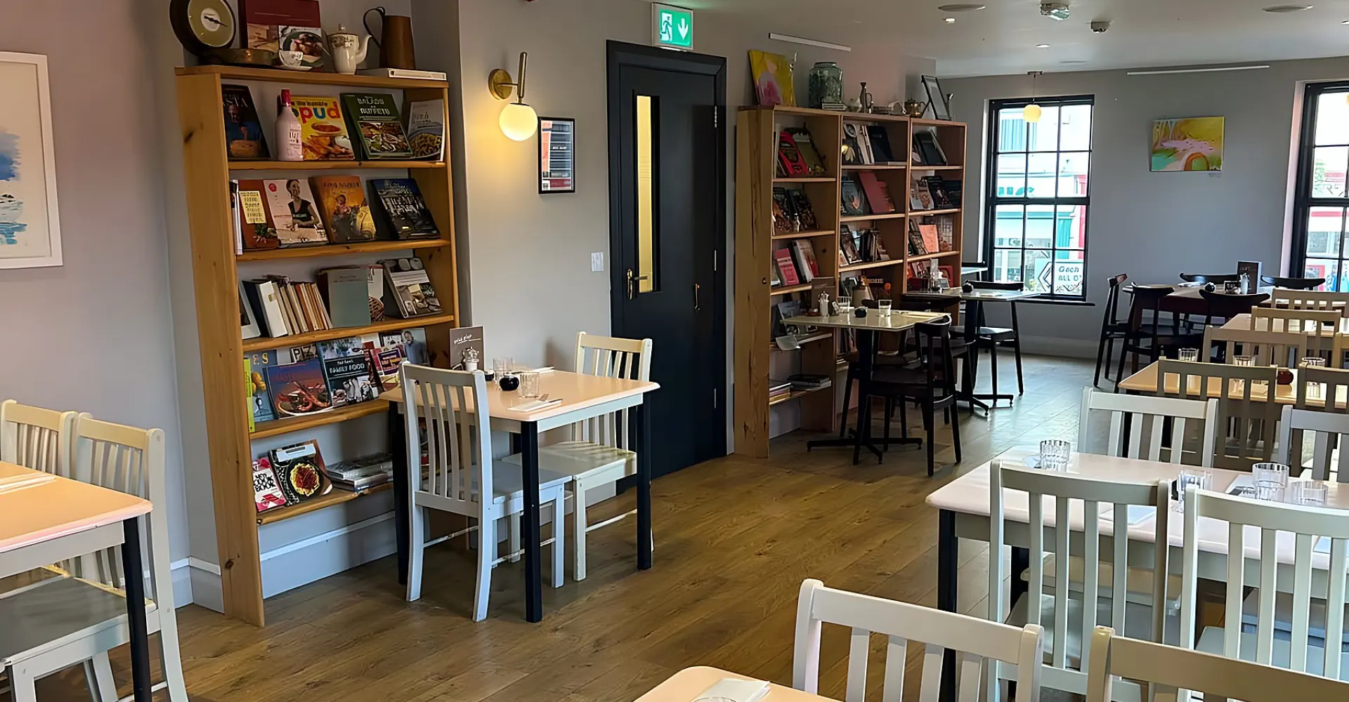 The upstairs dining room with bookshelves and wooden tables