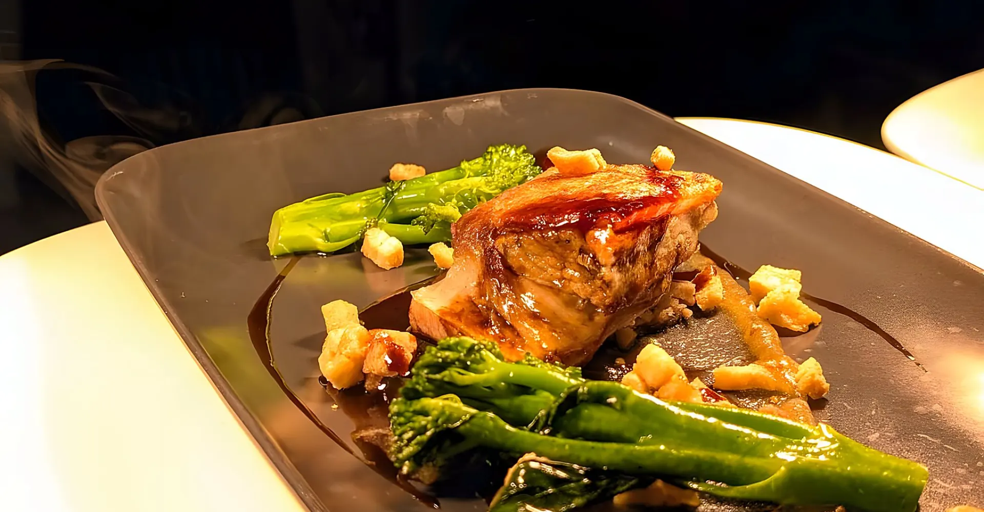 Crispy pork belly with apple purée and broccoli