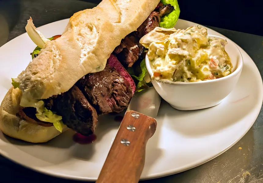 Steak sandwich on ciabatta with potato salad